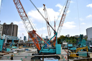 Fototapeta na wymiar Huge land development site. Crawler crane Lattice boom 