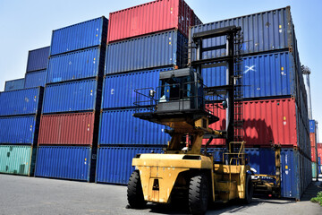 Toplifter handling cargo container loading to container trailer in import export logistic zone:...