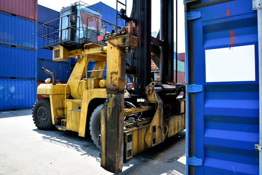 Toplifter handling cargo container loading to container trailer in import export logistic zone: Shipping industry