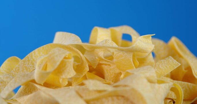 Homemade pappardelle pasta dry slowly rotates.