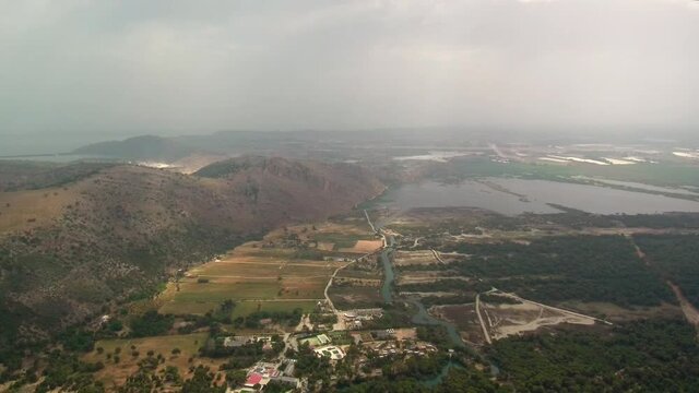 Kalogria landscape and beach during overcast day, drone tilting shot