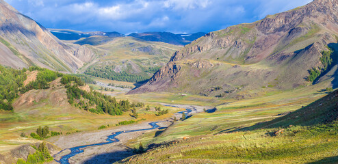 Fototapeta premium Mountain valley. Tundra, treeless mountain slopes, wild river. Traveling in the mountains, trekking.