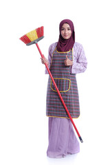 Muslim asian wife holding a broom