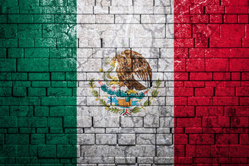 National flag of Mexico on brick  wall background.The concept of national pride and symbol of the country. Flag  banner on  stone texture background.