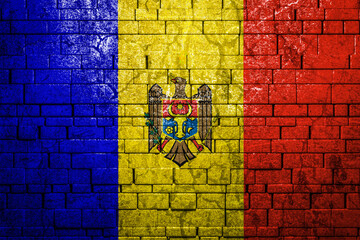 National flag of Moldova on brick  wall background.The concept of national pride and symbol of the country. Flag  banner on  stone texture background.