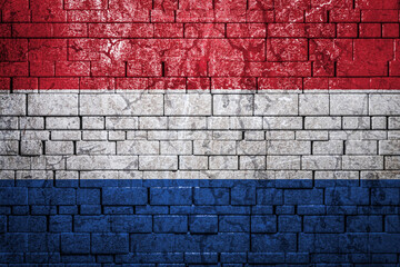National flag of Netherlands on brick  wall background.The concept of national pride and symbol of the country. Flag  banner on  stone texture background.
