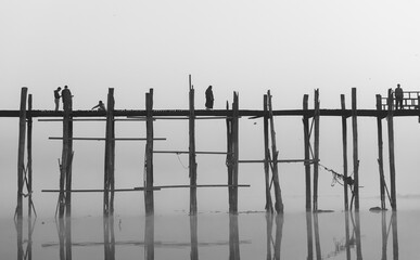 people walk on the teak wood bridge