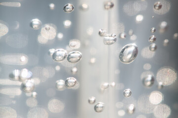 A selective focus shot a abstract background of glowing and iridescent bubbles. Blurred background.