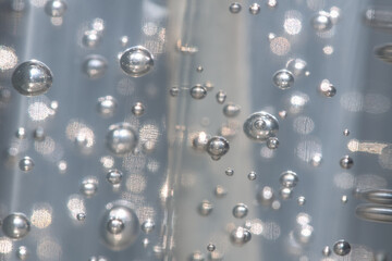 A selective focus shot a abstract background of glowing and iridescent bubbles. Blurred background.