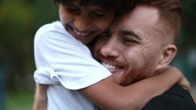 Father and son embrace, real life and authentic love relationship. Ethnically diverse parent and child, interracial