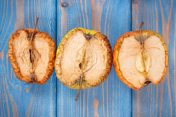 Old moldy apple, concept of unhealthy and disgusting fruit
