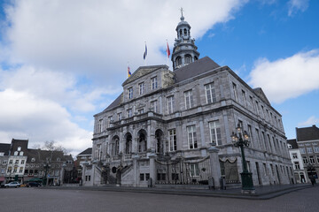 Fototapeta na wymiar The Maastricht city hall on the Markt in the center of Maastricht with blue sky and clouds