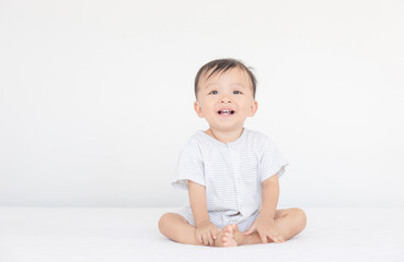 Happiness and smiling baby boy laughing on bed, kids playing concept