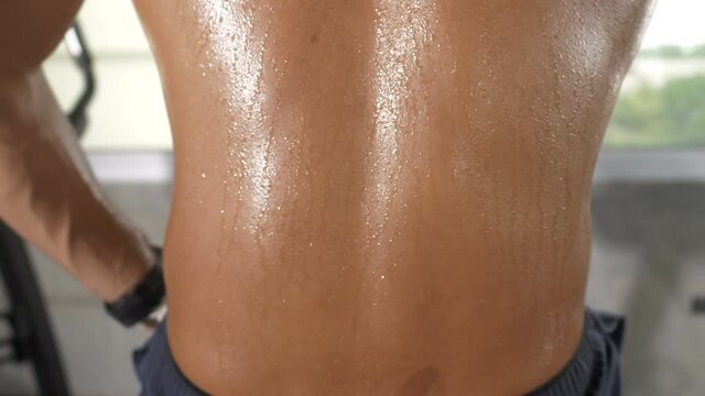 movement of sportman body skin, sweat dripping drop on body skin of sport man after workout, exercise concept for weight loss and good health, new normal lifestyle