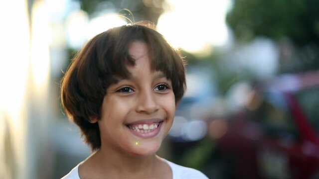 Handsome child boy outside smiling. Ethnically diverse kid portrait
