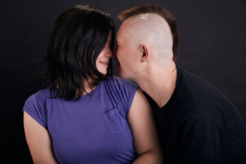 Portrait of mixed race couple in the studio. Two people together hug.