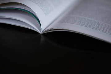 Open magazine with narrow depth of field on a dark table