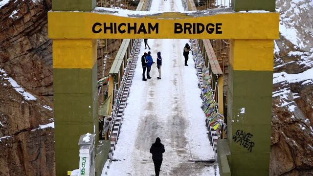 Tilt up shot of chicham bridge with people enjoying on the bridge