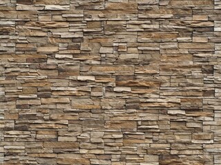 Stone cladding wall made of striped stacked slabs of natural brown rocks. Panels for exterior .