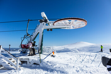Ski, skiing, skiers on ski lift. Happy people enjoying winter vacations in mountains. Winter holidays
