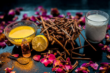 Face mask of manjistha or Indin madder root on a black wooden surface consisting of manjistha roots powder, lemon, milk and some essential rose oil. Face mask used for minor skin infections and acne.