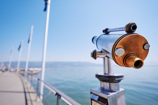 Coin Operated Spyglass viewer next to the lakeside promenade looking out to the bay on Lindau's harbor.