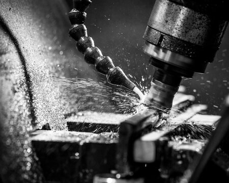 Close up black and white photo of rotary cutting tool in action.