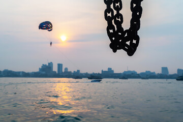 the selective focus picture of Steel chain, Pattaya city background, Thailand