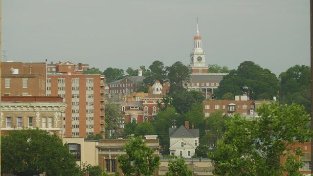 Establishing shot of charming old Southeast town with a tall clock tower
