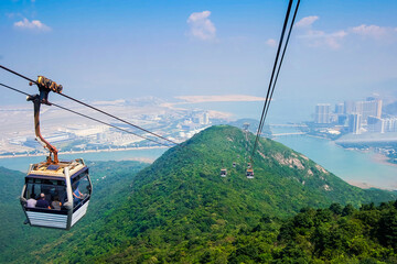 Skyline cable car with green mountains and ocean landscape background