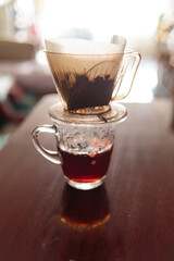 Instant freshly brewed cup of coffee or paper dripping bag on a cup.