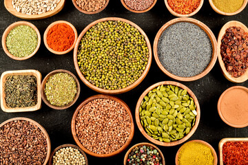 Different kinds of colorful spices in wooden bowls. Top view of spices.
