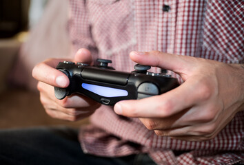 Man plays with gamepad in hands © Дарья Шварц