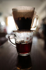 Instant freshly brewed cup of coffee or paper dripping bag on a cup.