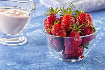 Fresh strawberries with freshly prepared yogurt on the table
