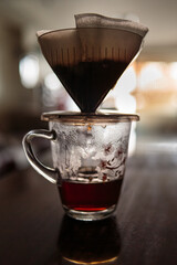 Instant freshly brewed cup of coffee or paper dripping bag on a cup.