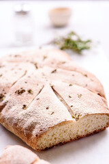 Homemade fresh baked Fougasse (French Bread) with thyme and olive oil on white background. Traditional Provencal dishes. Selective focus