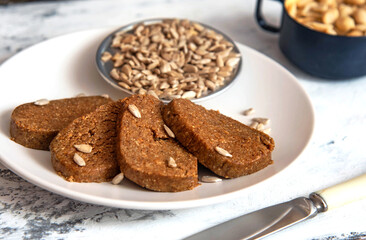 Homemade sunflower halva sliced on a white plate