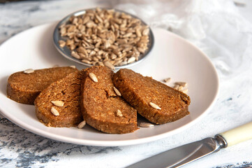 Homemade sunflower halva sliced on a white plate