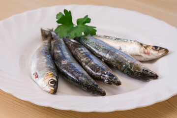 plate of fresh sardines with parsley on the plate
