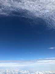 view of blue sky and white clouds from the  plane window