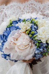 wedding bouquet of roses. bride holds flowers close-up