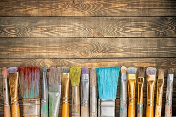 A row of artist paint brushes on desk