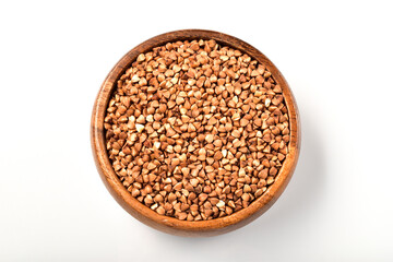 Buckwheat in wooden bowl isolated on white background