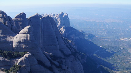 The rocky peaks of the mountains rise above the valleys of the province of Barcelona.