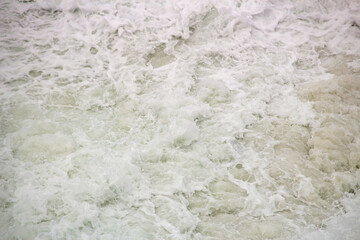 white foam of a wave at leblon beach in Rio de Janeiro.