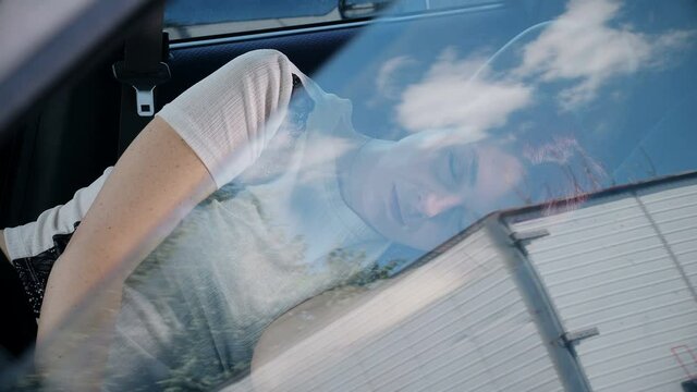 economic crisis - woman evicted from home is forced to sleep in the car