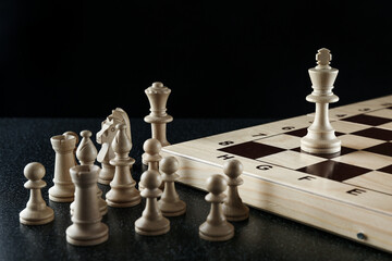 chess on dark background. one king remained in the game. eliminated players from the game.