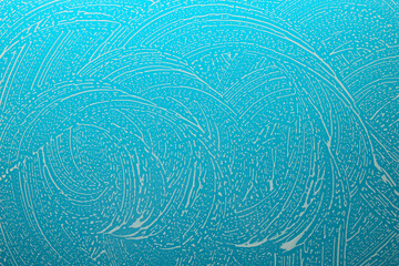 soap foam on glass on a blue background