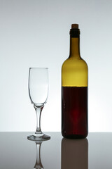 red wine bottle and wineglass on white background